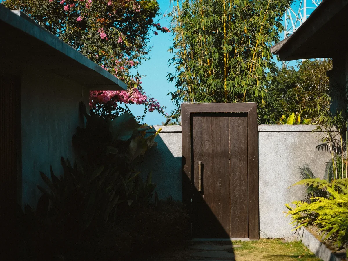 Modern wooden gate with landscaped entry